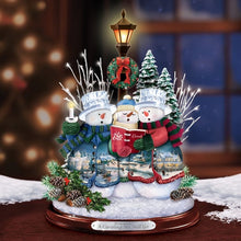 Load image into Gallery viewer, The Bradford Exchange "A Caroling We Will Go" Crystal Snowman Trio Illuminated Hand-crafted Sculpture Christmas Decoration with Holiday Artwork by Thomas Kinkade 10-inches - RCE Global Solutions