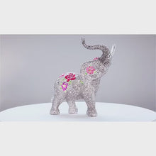 Load and play video in Gallery viewer, The Hamilton Collection Blake Jensen Legends of Fortune Elephant Figurine Features Hand Set Faux Gems in Pave Style Setting With Bas-relief Floral Patterns and Swarovski Crystal Accents 7"-Inches