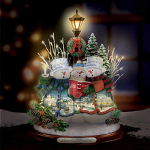 Load image into Gallery viewer, The Bradford Exchange "A Caroling We Will Go" Crystal Snowman Trio Illuminated Hand-crafted Sculpture Christmas Decoration with Holiday Artwork by Thomas Kinkade 10-inches
